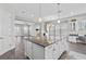 Bright kitchen island with granite countertops, adjacent to an open living space at 1379 Kiawah St, Celebration, FL 34747
