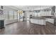 Spacious kitchen with hardwood floors, large island, stainless appliances, and lots of natural light at 1379 Kiawah St, Celebration, FL 34747