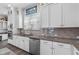 Modern kitchen features stainless appliances, granite countertops, and white cabinetry at 1379 Kiawah St, Celebration, FL 34747