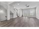 Open concept living room with wood-look floors, staircase, and doors to the outside at 1379 Kiawah St, Celebration, FL 34747