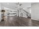 Open concept living room boasts hardwood floors and a staircase with black metal accents at 1379 Kiawah St, Celebration, FL 34747