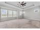 Spacious main bedroom with tray ceiling, fan, and multiple windows providing plenty of natural light at 1379 Kiawah St, Celebration, FL 34747