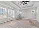 Spacious main bedroom with tray ceiling, fan, and multiple windows providing plenty of natural light at 1379 Kiawah St, Celebration, FL 34747