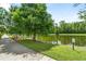 Scenic pond view with mature trees, lush greenery, and a peaceful walking path at 1379 Kiawah St, Celebration, FL 34747
