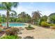 Community pool featuring palm trees, lounge chairs, pergola, and paved deck area at 1379 Kiawah St, Celebration, FL 34747