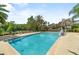Community pool with a pergola, seating, lounge chairs, and paved deck area at 1379 Kiawah St, Celebration, FL 34747