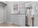 Custom walk-in closet features built-in shelving, drawers, and hanging space for optimal organization at 1379 Kiawah St, Celebration, FL 34747