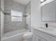 Bathroom featuring updated tile, shower and tub combo and modern fixtures at 14639 Musket Fire Ln, Orlando, FL 32837