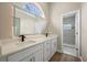 Elegant bathroom with double vanity, quartz countertop, backlit mirror and tiled shower at 14639 Musket Fire Ln, Orlando, FL 32837