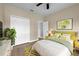 Cozy bedroom with bright decor, a ceiling fan, a large bed, and convenient closet space at 14639 Musket Fire Ln, Orlando, FL 32837