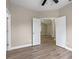 A bedroom displaying light wood floors, neutral walls, and white doors opening to another room at 14639 Musket Fire Ln, Orlando, FL 32837