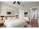 Bright bedroom with a large bed, contemporary decor, a ceiling fan, and an ensuite bathroom at 14639 Musket Fire Ln, Orlando, FL 32837