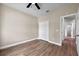 A light and airy bedroom with light wood floors, a double closet, and a doorway to an adjacent room at 14639 Musket Fire Ln, Orlando, FL 32837