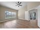 Bright bedroom with wood floors, ceiling fan, and sliding glass doors to the pool at 14639 Musket Fire Ln, Orlando, FL 32837