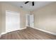 A comfortable bedroom with light wood floors, a double closet, and a doorway leading to another room at 14639 Musket Fire Ln, Orlando, FL 32837