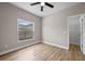 Cozy bedroom featuring light wood floors, a window with natural light, and an access door to the ensuite bathroom at 14639 Musket Fire Ln, Orlando, FL 32837