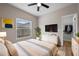 Relaxing bedroom with a large window, modern decor, a ceiling fan, and a closet for ample storage at 14639 Musket Fire Ln, Orlando, FL 32837