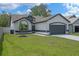 Charming single-Gathering home with a well-manicured lawn, mature landscaping, and attached two-car garage at 14639 Musket Fire Ln, Orlando, FL 32837