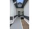 The front entrance is framed by modern planters and an elegant front door with sidelight window at 14639 Musket Fire Ln, Orlando, FL 32837