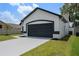 Charming single-Gathering home with a well-manicured lawn, mature landscaping, and attached two-car garage at 14639 Musket Fire Ln, Orlando, FL 32837