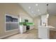 Beautiful modern kitchen with white cabinets, stainless steel appliances, and a green tile backsplash at 14639 Musket Fire Ln, Orlando, FL 32837