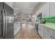 Spacious modern kitchen with stainless steel appliances, white cabinets, and an open view of the living area at 14639 Musket Fire Ln, Orlando, FL 32837