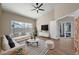 Modern living room with high ceilings, large windows, stylish furniture, and access to the outdoor pool area at 14639 Musket Fire Ln, Orlando, FL 32837