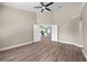 Spacious living room featuring wood floors, ceiling fan and doorway view to kitchen at 14639 Musket Fire Ln, Orlando, FL 32837