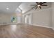 Inviting living room showcasing light wood floors, a vaulted ceiling with fan, and a view of the front door at 14639 Musket Fire Ln, Orlando, FL 32837