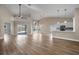 The living space features high ceilings, sleek flooring, and an open floor plan to the kitchen and dining areas at 14639 Musket Fire Ln, Orlando, FL 32837