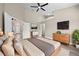 Bright main bedroom with a ceiling fan, ensuite bathroom, and large windows offering plenty of natural light at 14639 Musket Fire Ln, Orlando, FL 32837