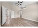Spacious main bedroom with light wood floors, an ensuite bathroom, and double doors leading to another room at 14639 Musket Fire Ln, Orlando, FL 32837