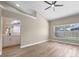 The main bedroom features light wood floors, an ensuite bathroom, and a window overlooking the pool at 14639 Musket Fire Ln, Orlando, FL 32837