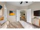 Tranquil primary bedroom with luxury vinyl floors and doorway view to the living room at 14639 Musket Fire Ln, Orlando, FL 32837