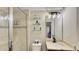 Modern bathroom featuring a granite vanity top, single sink, walk-in shower, and additional shelving for toiletries at 148 Whirlaway Dr, Davenport, FL 33837