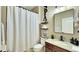 Well-lit bathroom featuring granite countertop, dark cabinets, decorative 'spa' theme, and walk-in shower at 148 Whirlaway Dr, Davenport, FL 33837