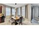 Dining area with wood table, upholstered chairs and bench seating, and large windows for natural light at 148 Whirlaway Dr, Davenport, FL 33837