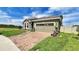 Well-kept home with stone accents, a brick driveway, and green lawn, offering a welcoming and classic design at 148 Whirlaway Dr, Davenport, FL 33837