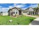 Charming home featuring a stone facade, manicured landscaping, and brick driveway, exuding curb appeal at 148 Whirlaway Dr, Davenport, FL 33837