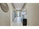 Hallway features neutral decor, decorative art, and a front door with transom window at 148 Whirlaway Dr, Davenport, FL 33837