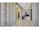 Entryway with neutral walls and tile floors lead to an arched entryway to the living room and dining area at 148 Whirlaway Dr, Davenport, FL 33837