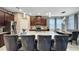 An elegant kitchen showcasing a granite island, dark wood cabinetry, and modern appliances at 148 Whirlaway Dr, Davenport, FL 33837