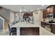 Modern kitchen island with bar stools, granite countertops, and ample cabinet space at 148 Whirlaway Dr, Davenport, FL 33837