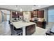 Large kitchen island with seating, granite countertops, and stainless steel appliances at 148 Whirlaway Dr, Davenport, FL 33837