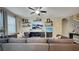 Open living area features a large sectional sofa, mounted television, and floating display shelves at 148 Whirlaway Dr, Davenport, FL 33837