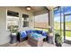 Covered outdoor seating area with fire pit, ceiling fan and a view of the backyard at 148 Whirlaway Dr, Davenport, FL 33837