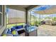 Covered patio with outdoor kitchen, seating area, and a beautiful view at 148 Whirlaway Dr, Davenport, FL 33837