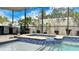 Inviting spa with custom tile work, perfect for lounging on a hot day with overhead shade and privacy wall at 148 Whirlaway Dr, Davenport, FL 33837