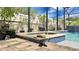 Relaxing spa with blue tile accents and a hat and sun glasses on the tile coping creating a vacation vibe at 148 Whirlaway Dr, Davenport, FL 33837