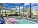Enclosed pool and spa area with an outdoor kitchen and shaded patio, offering a private and luxurious retreat at 148 Whirlaway Dr, Davenport, FL 33837